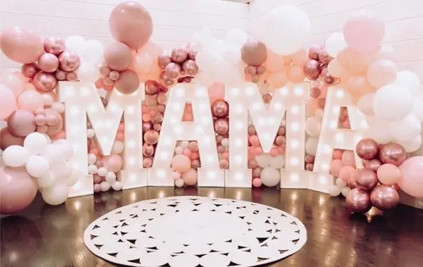 Giant MAMA marquee letters in a cloud of blush, rose gold and white balloons